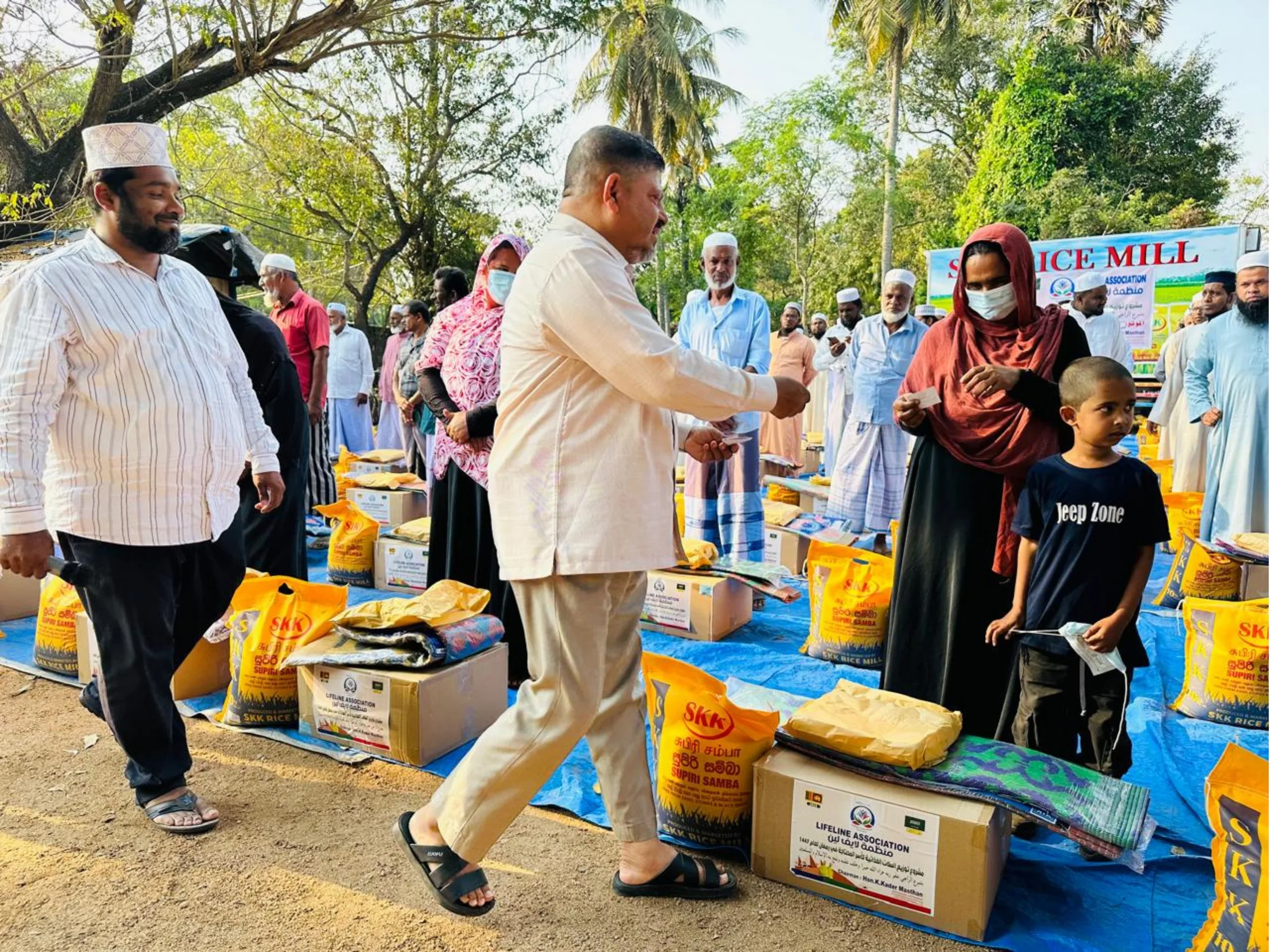 Lifeline volunteers handing dry-ration packs to community members during Ramadan